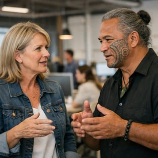 photographic contemporary woman mid 50s deep in conversation with a male who is Maori and around the same age Open office behind them