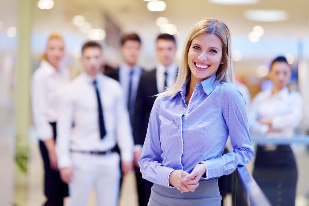 business woman  with her staff,  people group in background at modern bright office indoors